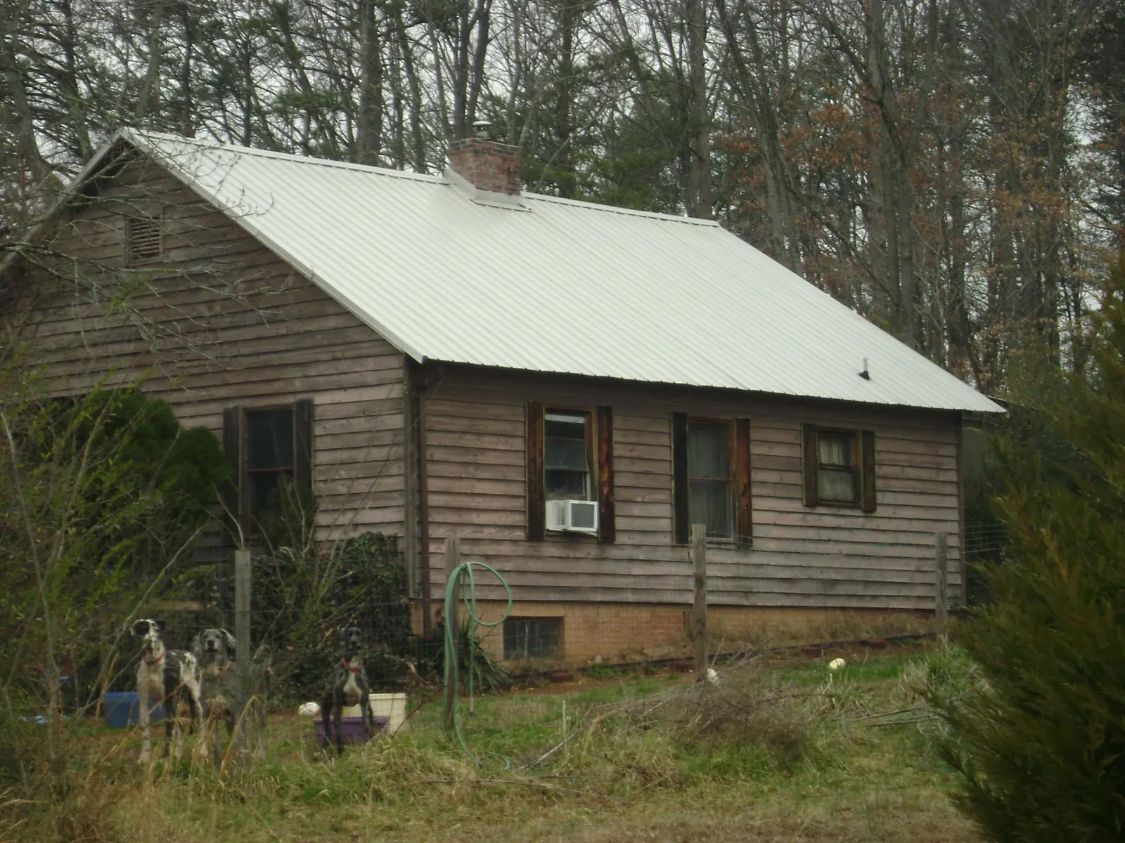 White metal roof on an old wood sided farmhouse, from a Asphalt Shingle Roof Repair job in New Boston
